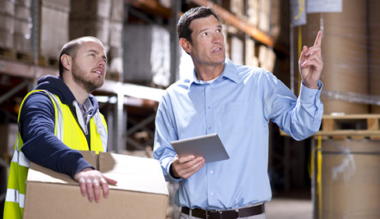 warehouse manager checks something with his supervisor